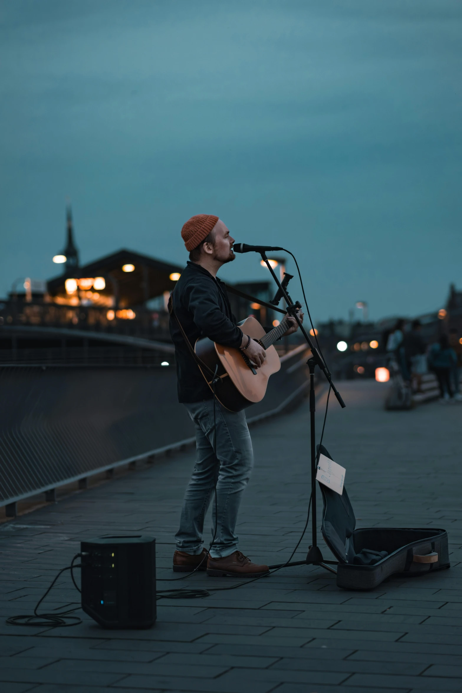 a man on the street with a guitar