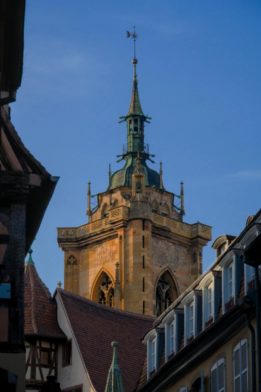 a tower with a pointed roof and a clock on top