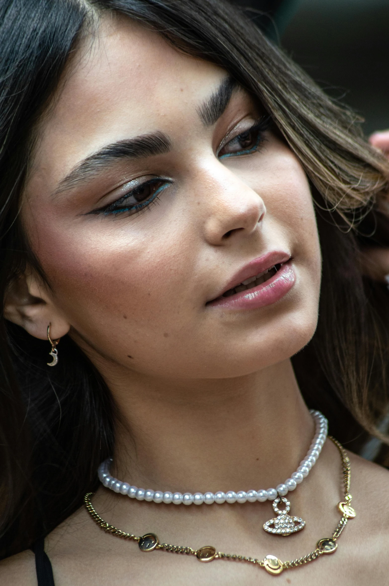 a close up of a person wearing jewelry