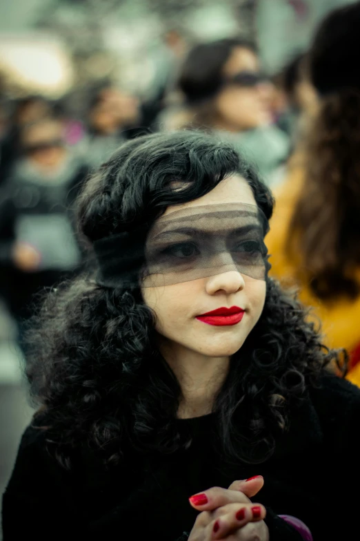 a woman is wearing veil and red lips