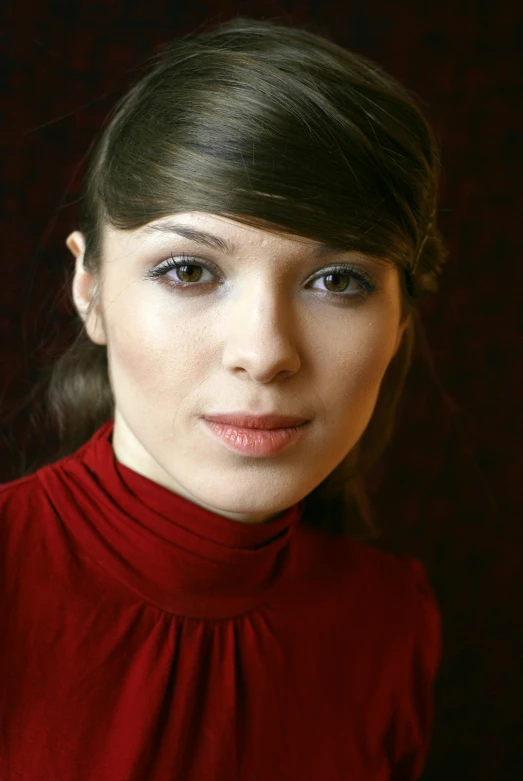 a young woman in a red shirt and a brown background