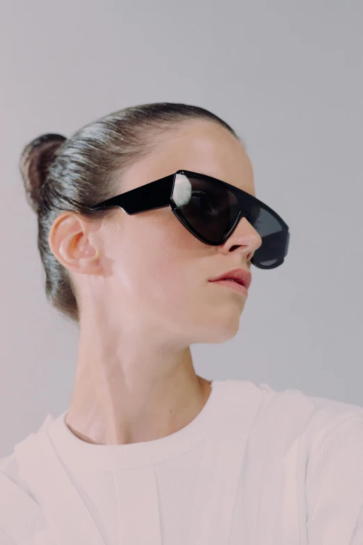 a woman wearing a black pair of sunglasses