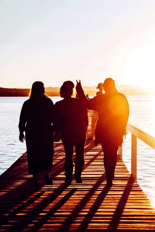 a family is walking out onto a dock