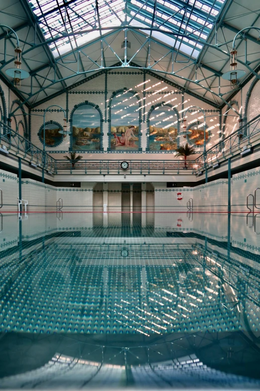 a large indoor swimming pool with clear water