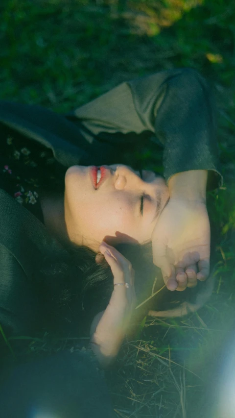 woman laying on the grass on her side