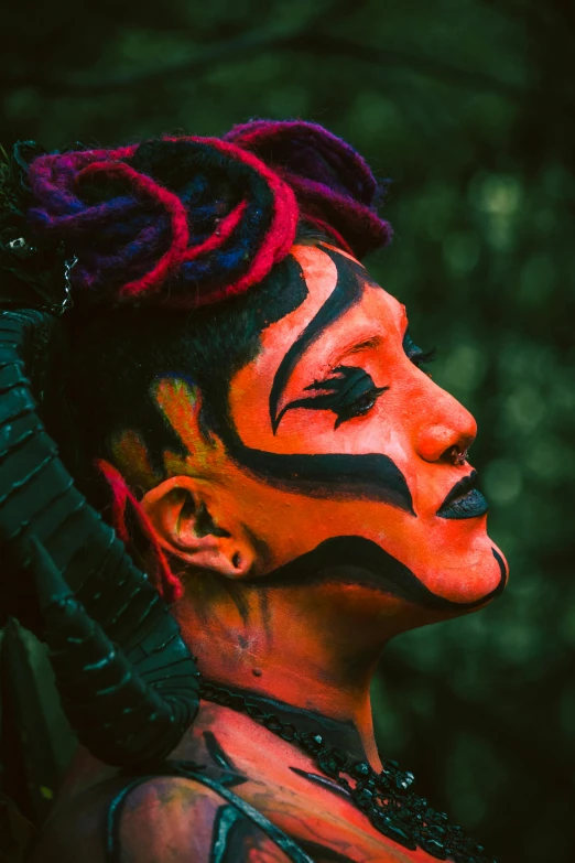 a man with dreadlocks on his ears and face