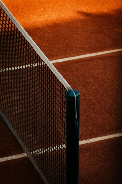 a brown tennis court with lines on it