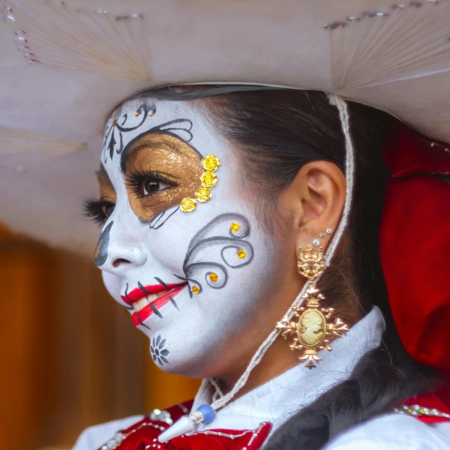 a woman with painted face and hat