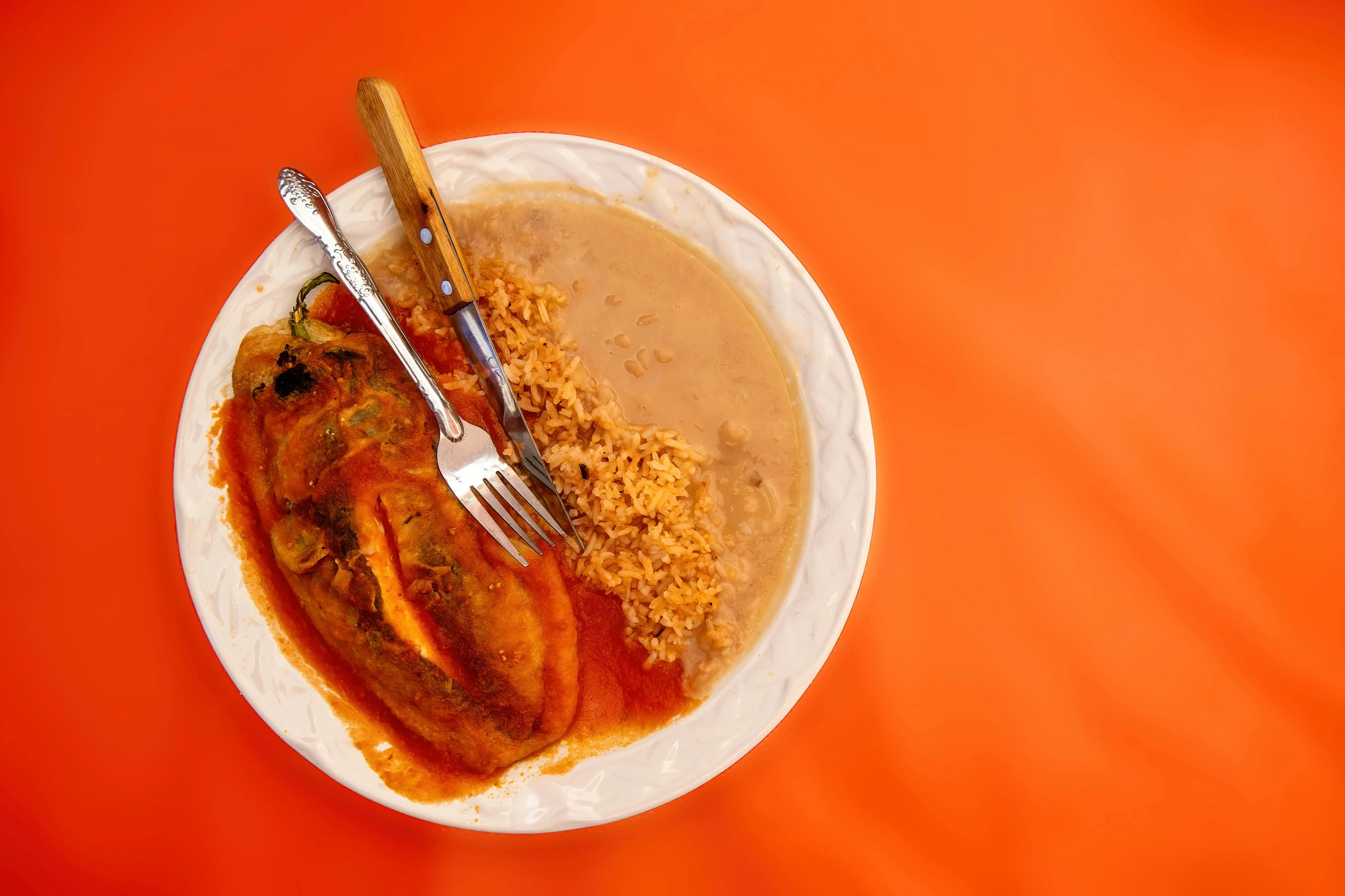 a plate of food on an orange surface