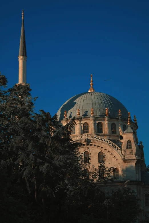 a large building with a massive spire in the background