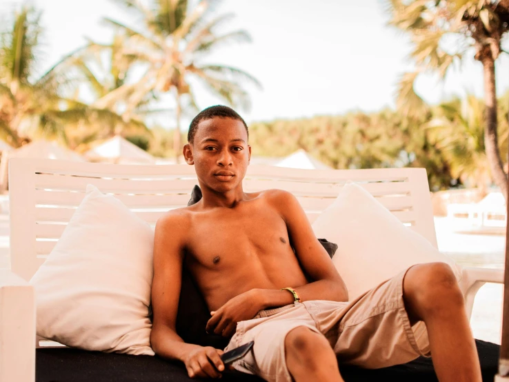 the young man is sitting on the chair