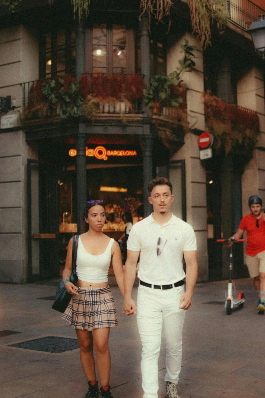 two people walking down the street together