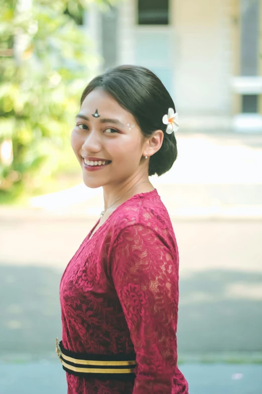 a woman wearing a pink dress smiling