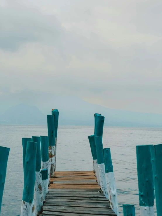 wooden pier with water in the background at day