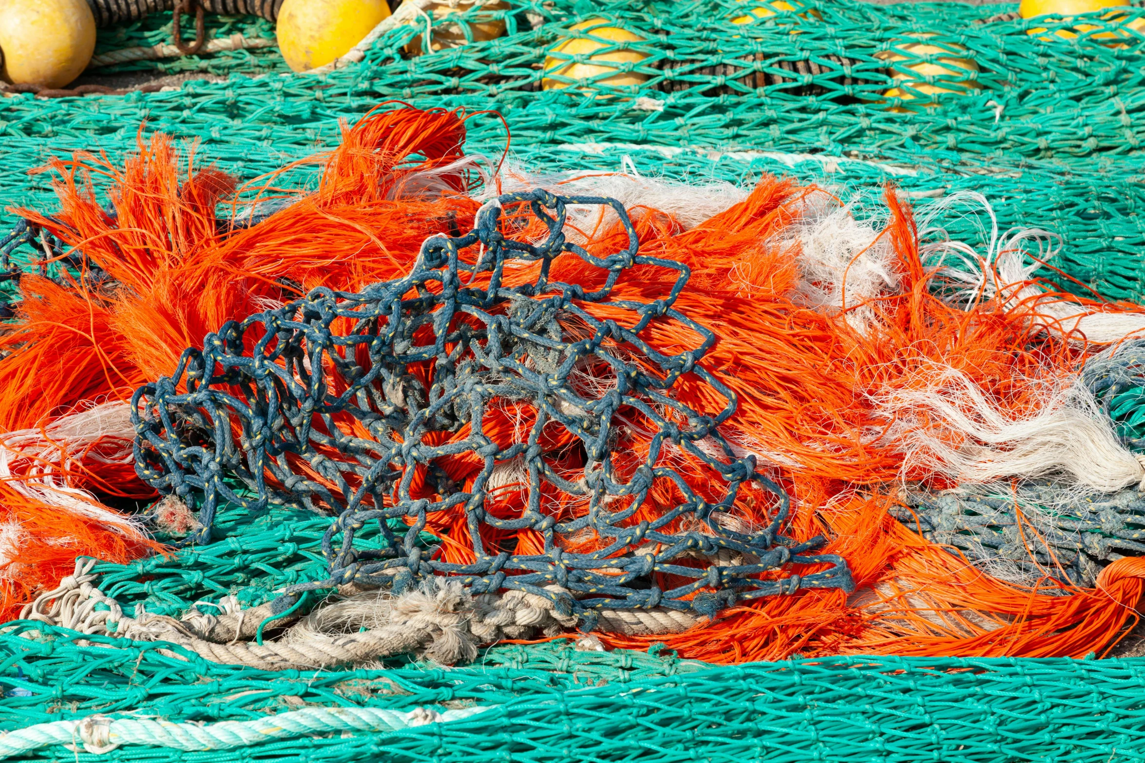 orange and grey ropes are on a turquoise colored tablecloth