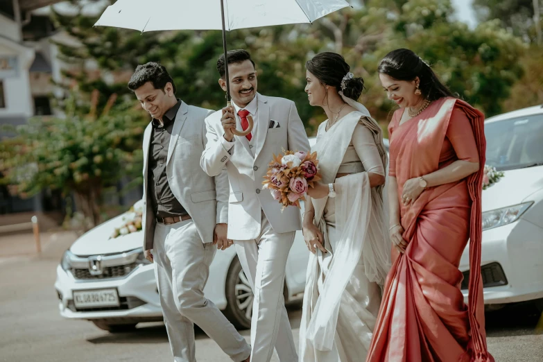 a couple walking away with their bride and groom