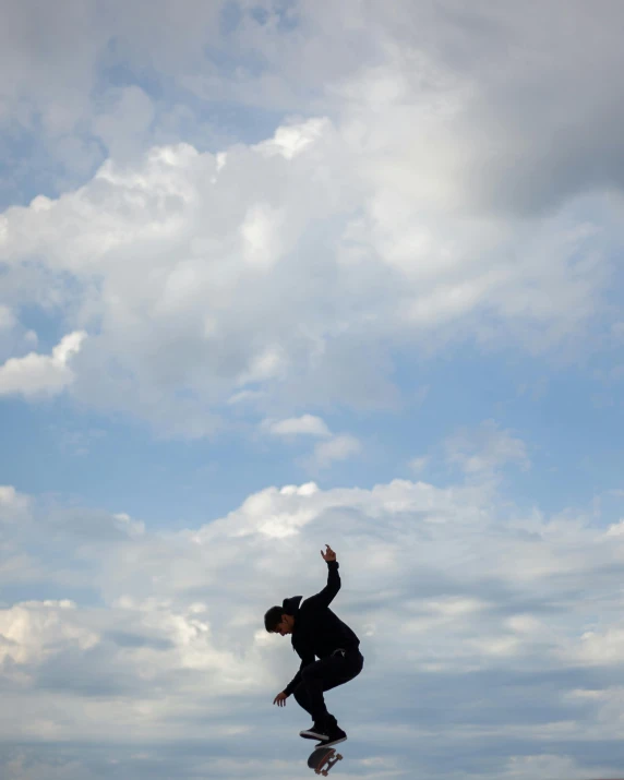 a boy is jumping high in the air on his skateboard