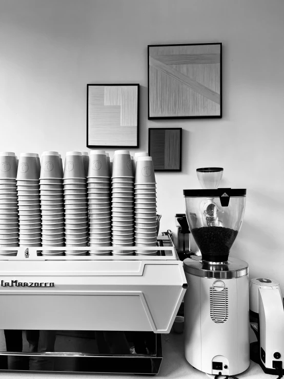 several coffee cups stacked on a white machine