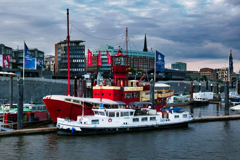 there is a large red and white boat tied up in the water