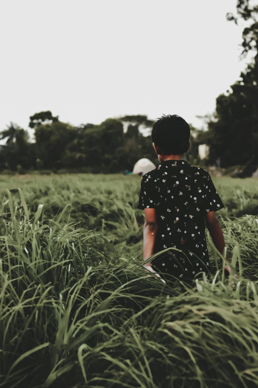 there is a little boy that is walking through the field