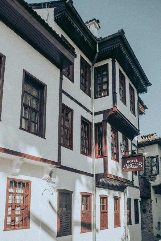 an old white building with brown trim