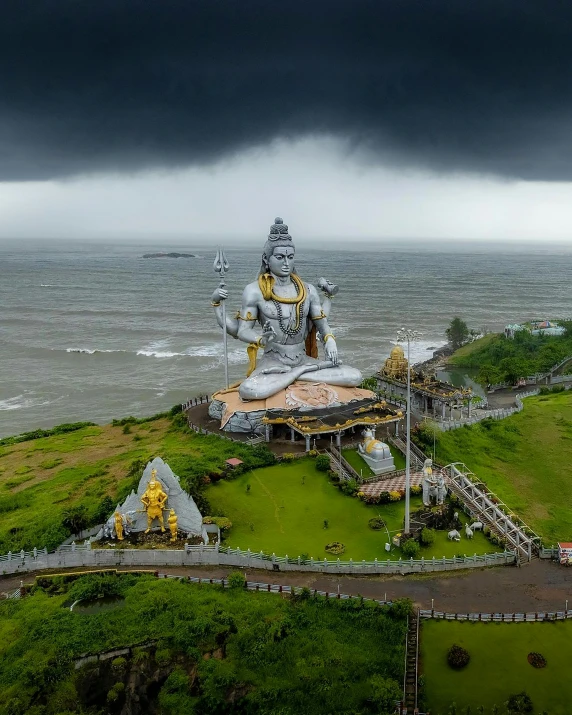 an aerial po of a large metal statue in a grassy area