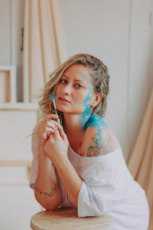 a woman with her hands on a hairbrush is posing for a portrait