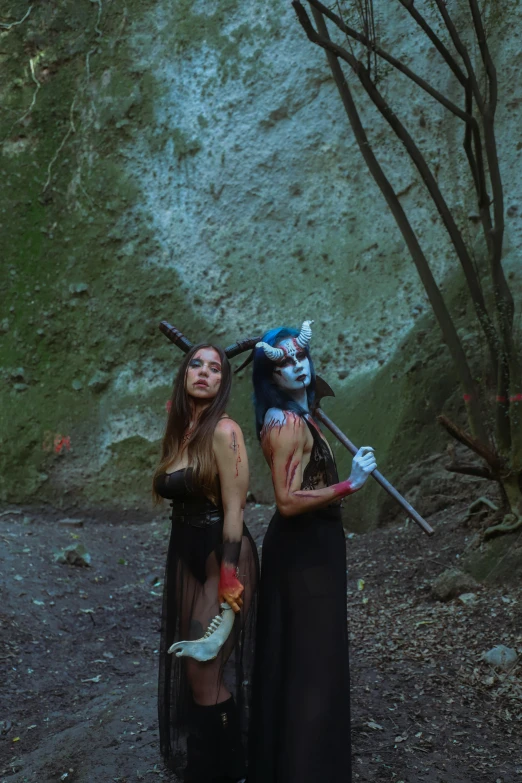 two women with masks posing for a po