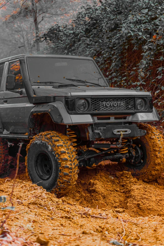 a jeep making some orange sand while driving around the desert