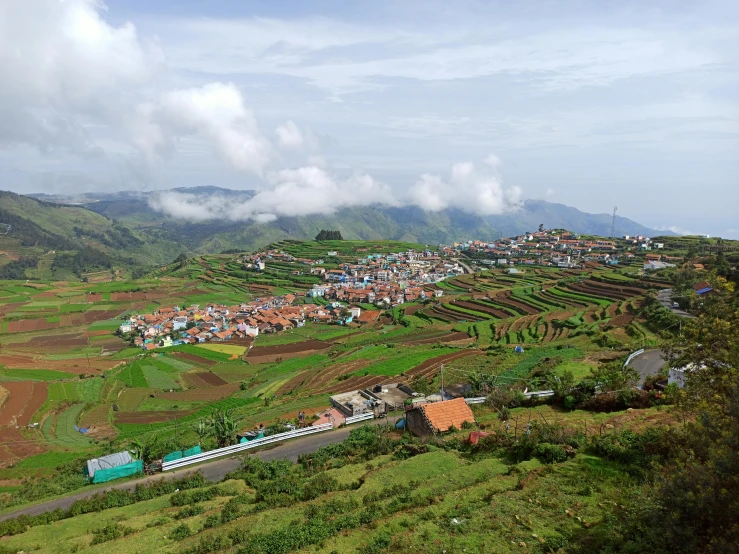 an aerial view of a mountain town and a river