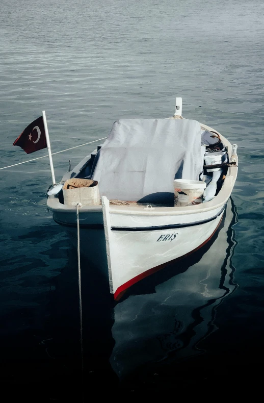 a boat with a turkish flag on it floating in the water