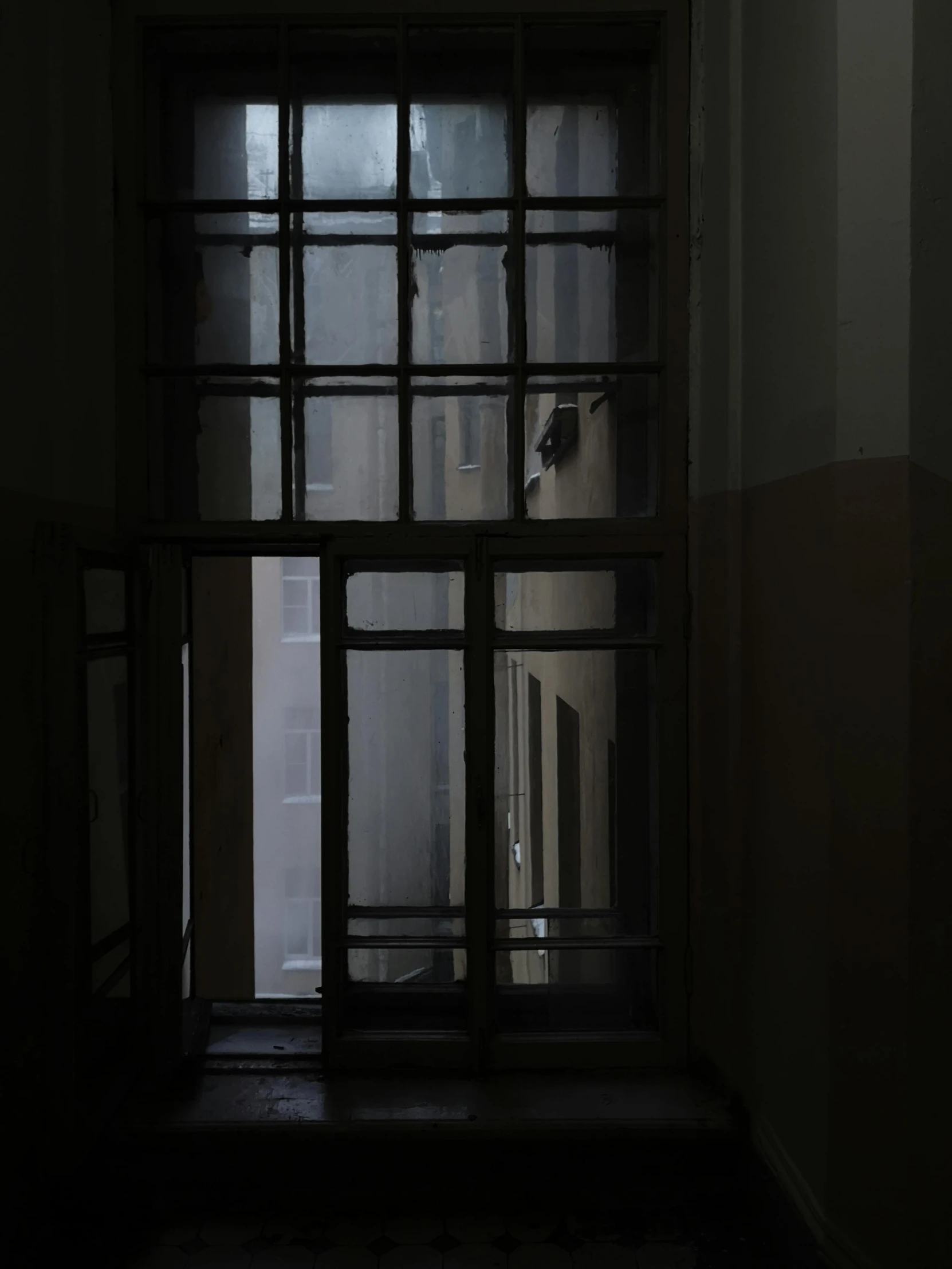 a doorway with glass doors lit up in the dark