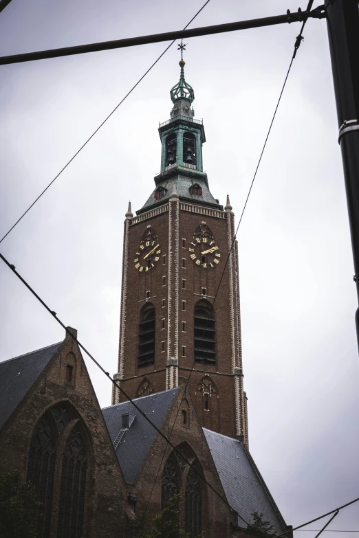 a building has a tall clock tower and a steeple