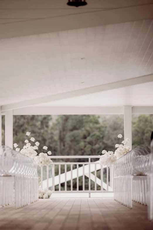 flowers are in vases on a white rail