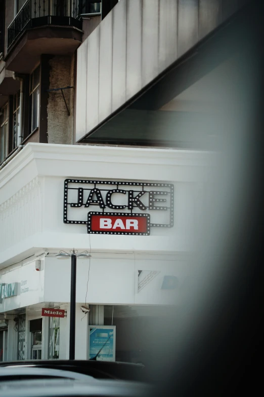 a street sign reads,'jack bar '