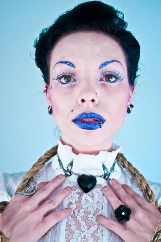 woman with very bright blue lips and makeup posing