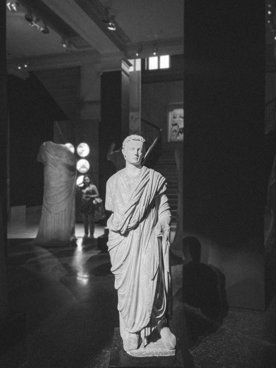 black and white pograph of statue in dark room