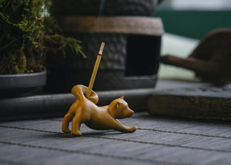 a plastic toy dog walking with an umbrella