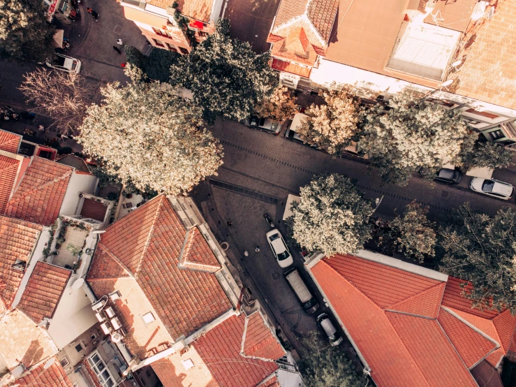 roofs and cars are seen from above with red tile roofing