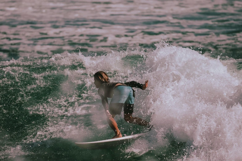 a man on a surfboard riding a wave