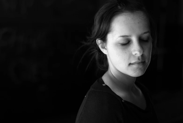 a woman is holding her phone and looking down