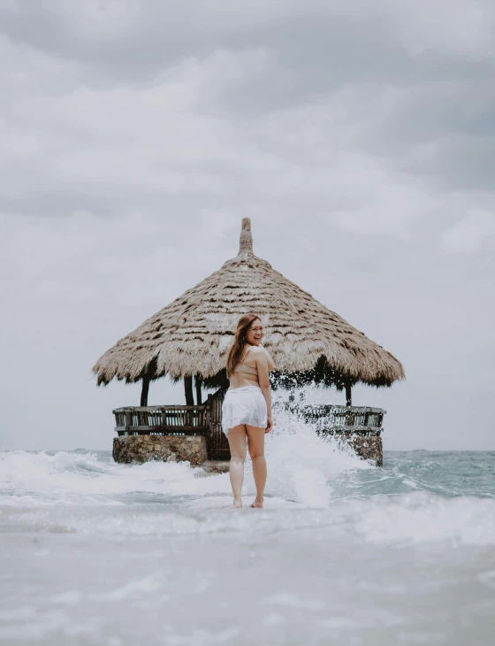 the woman in the bathing suit is walking through the water