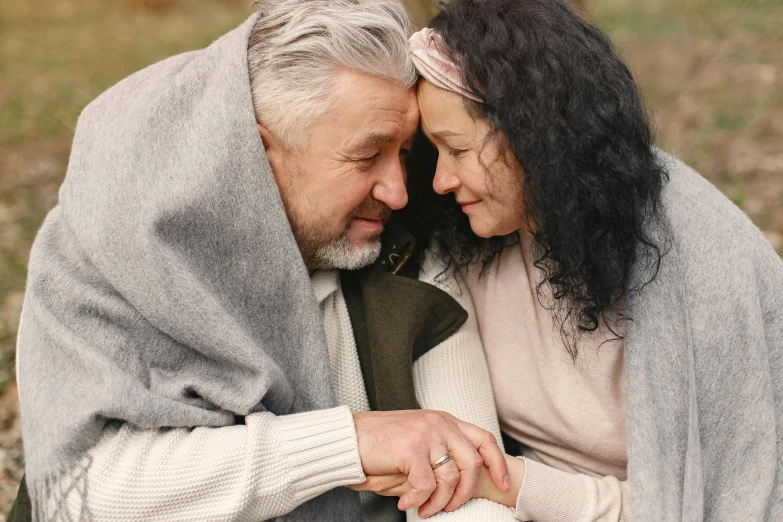 an older couple is holding each other close