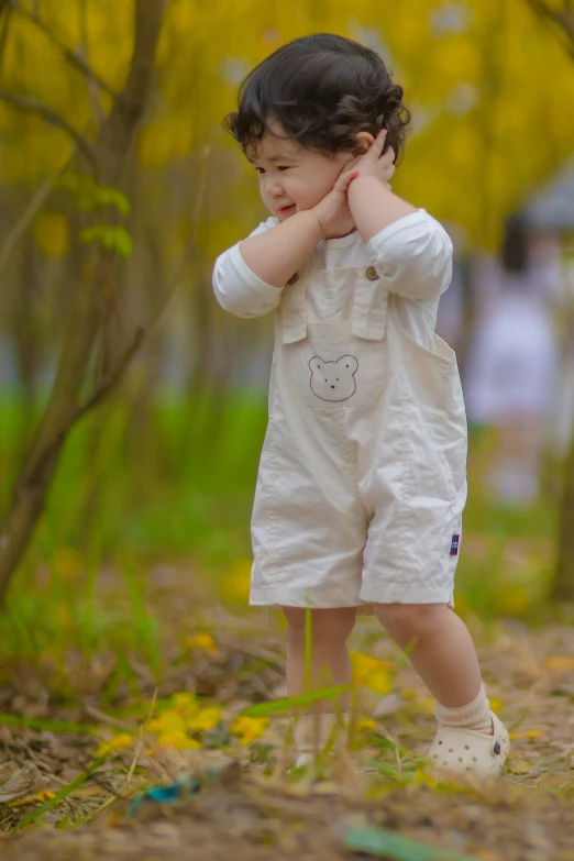 a toddler plays with a toy in the park