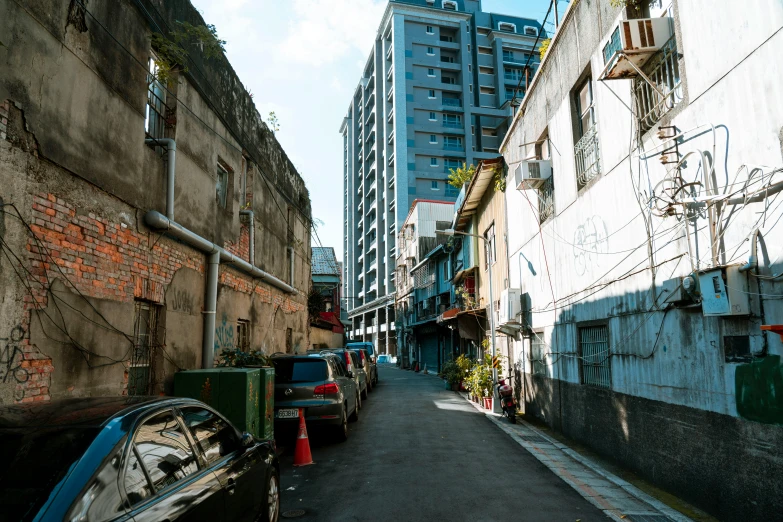 buildings next to street with cars parked on the side