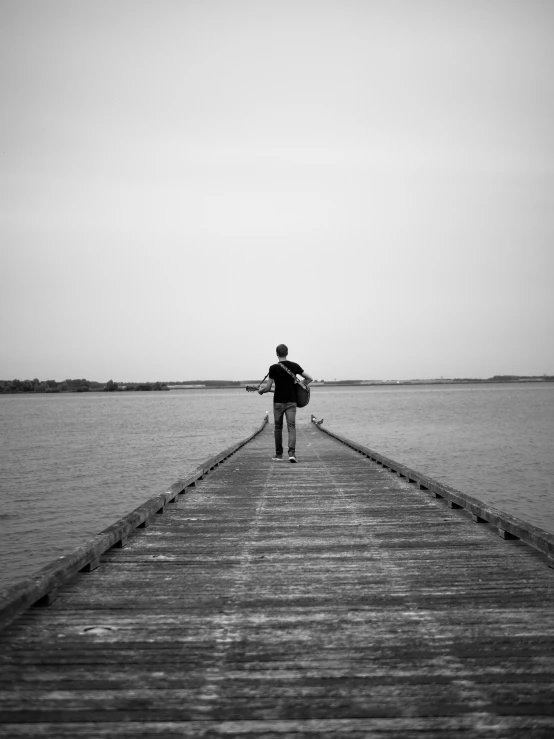 a person that is standing on the pier