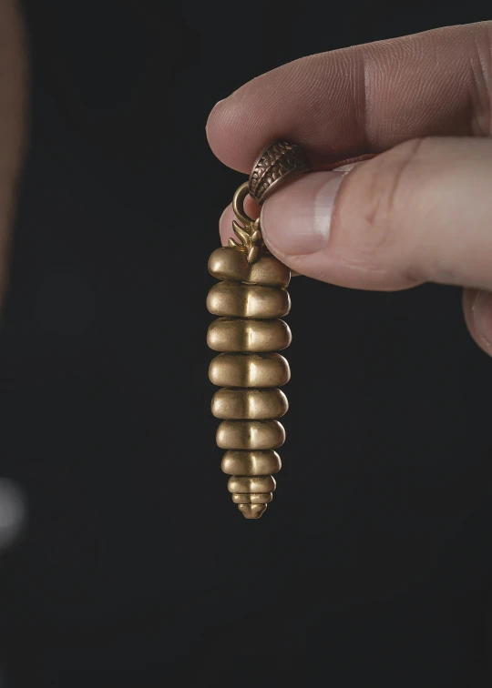 the underside of a tiny gold bug charm