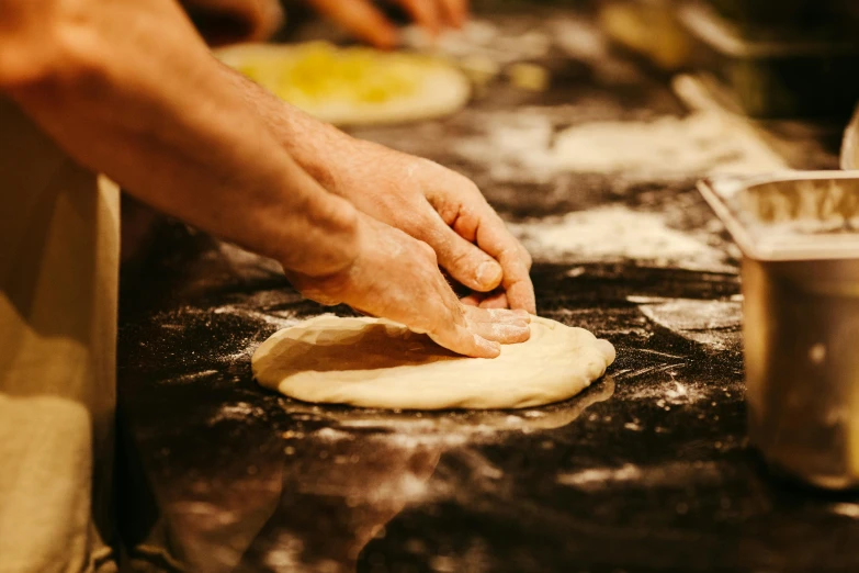 a person is rolling dough on the surface