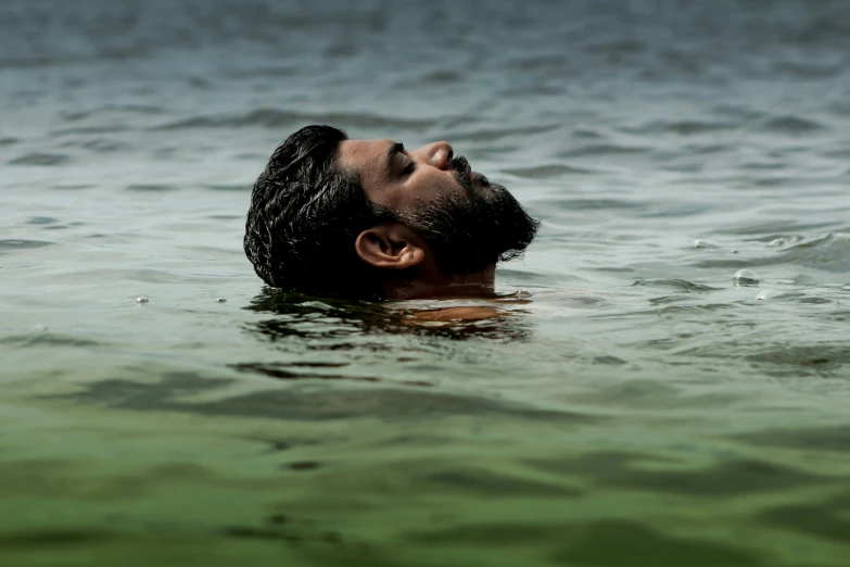 a man swims across a body of water