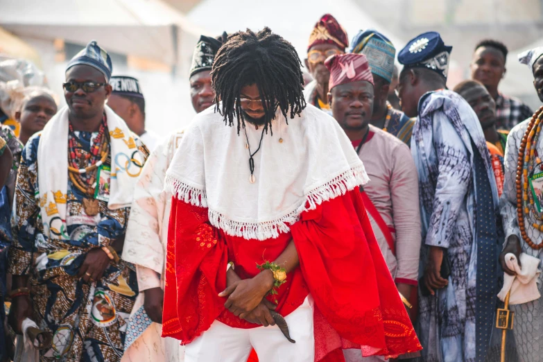 a man with dreadlocks is holding an object